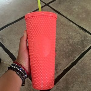 Pink studded Starbucks cup.